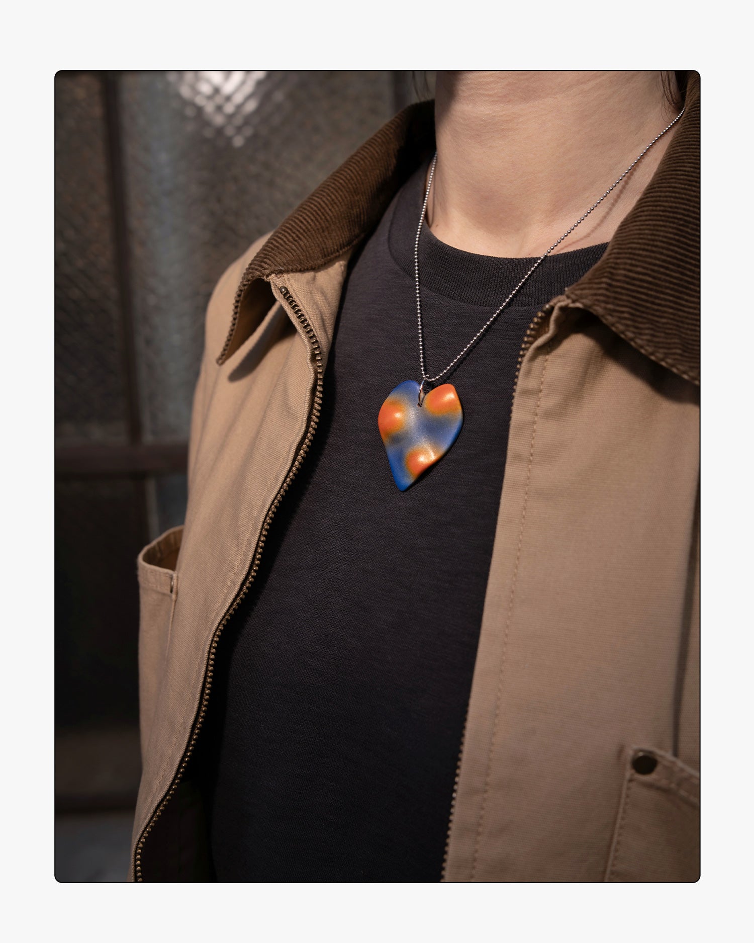 Detailed view of the topographic relief on the Photon heart pendant, showing the convex areas of the pendant.