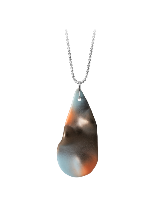 Close-up of a hand-painted ceramic teardrop pendant with deep brown, orange, and blue highlights suspended from a silver ball chain.